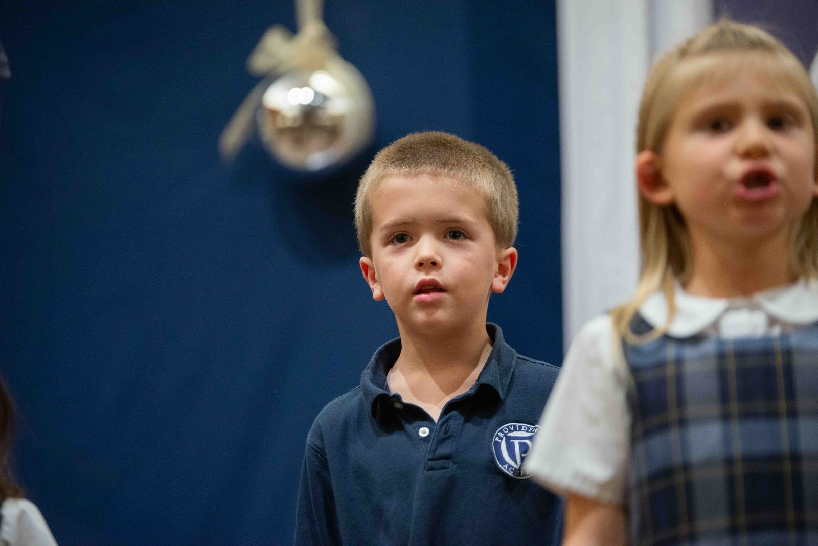 Two young students singing at Lessons and Carols