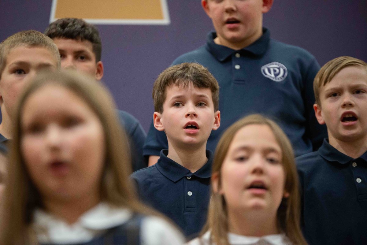 Lower school students singing in a row