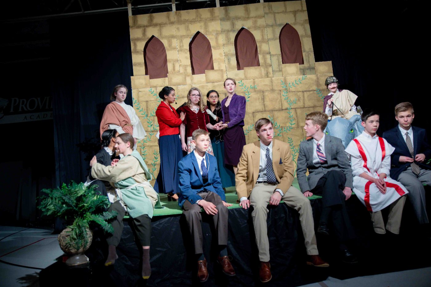 Upper school students on stage in costume for Shakespeare's Love's Labour's Lost